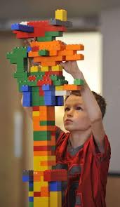 Kid builds a Lego tower